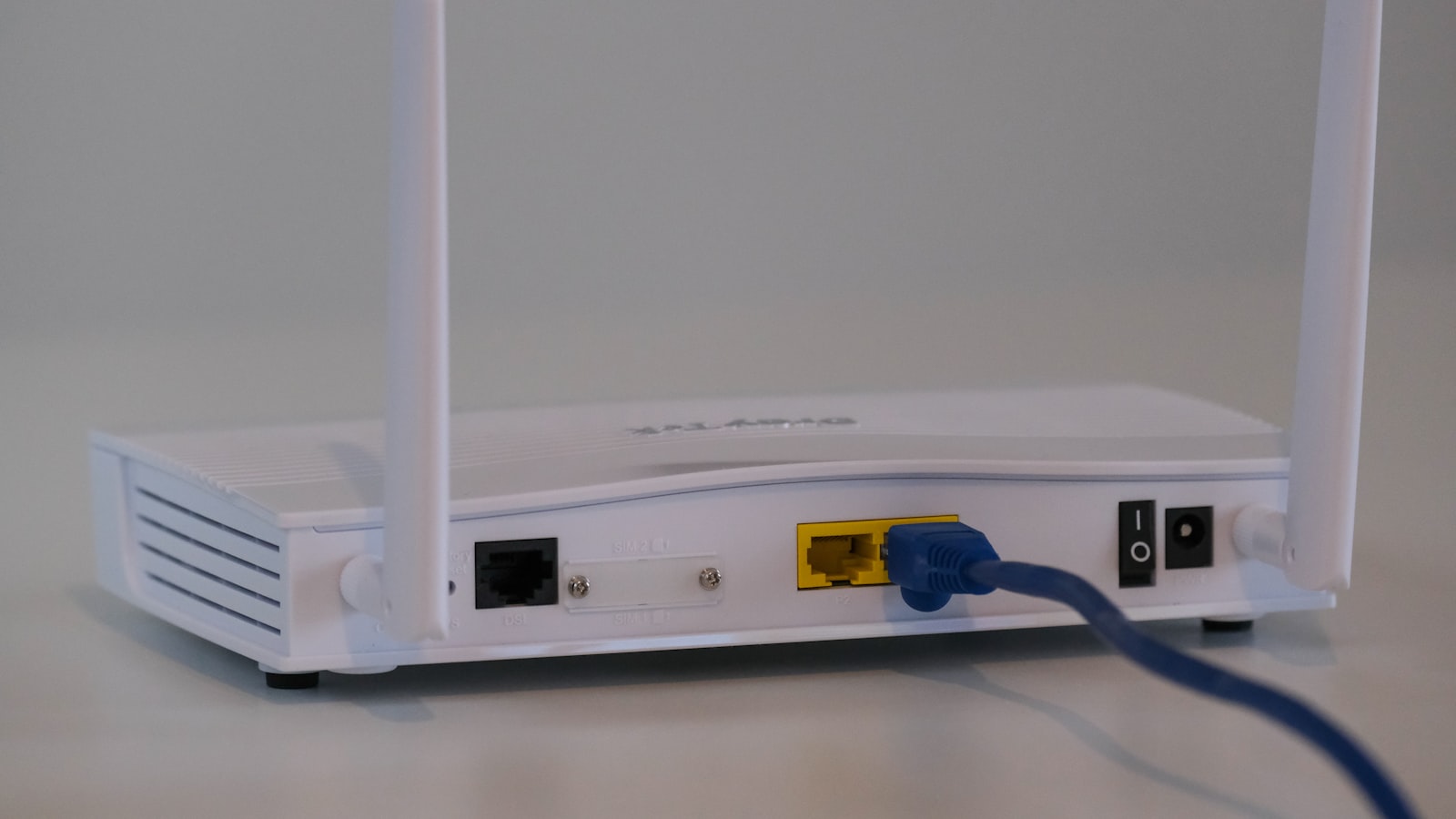 The back of a Wi-Fi router with an Ethernet cable plugged in