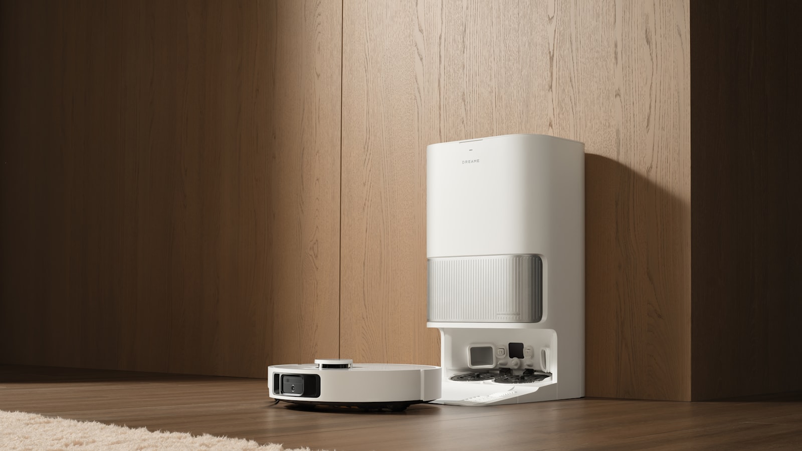 A robot vacuum parked at its tall self-emptying base station